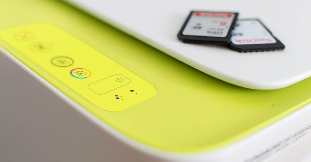 Detailed shot of a printer's control panel with SD cards on top, highlighting modern tech.