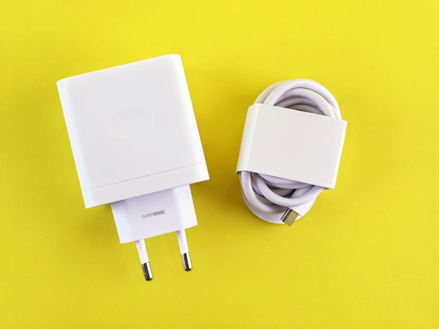 White SuperVOOC charger and cable on a bright yellow background, showcasing minimalist design.